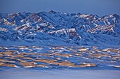 snow-covered sand dunes of the Khongoryn Els in the Gobi desert, Mongolia