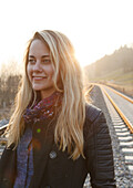Young woman between railroad tracks, Munich, Bavaria, Germany