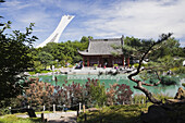 The Friendship Hall pavilion and the Dream Lake in summer at the Chinese Garden. The Olympic Stadium Tower is visible in the background. Montreal Botanical Garden, Montreal, Quebec, Canada, Not released, Editorial use only.