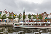 Canal tour boat on the River Trave at Travemünde in the medieval city of Lübeck, Germany.