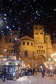 Cathedral of Trier and Chistmas market with Christmas pyramid while snowfall at night, Trier, Germany