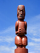 At various sacred spots, carved Maori figures stand guard, Whakatane, New Zealand.