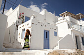 Woman in front of the houses in Hora, Serifos, Cyclades Islands, Greek Islands, Greece, Europe.