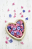 Heart shaped container filled with Hyacinth florets varietes Pink Pearl and Blue Star.