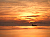 Fishing boat at sunrise, lake Chiemsee, Bavaria, Germany
