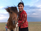 Young woman with Mongolian horse, Gorkhi-Terelj National Park, Toev, Mongolia