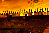 Wine bottles on a rack in restaurant, Verona, Veneto, Italy
