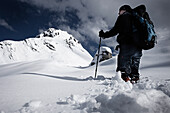 Hiker making tracks in fresh snow, On the way to Lamsenjoch hut via western Lamsenjoch, Karwendel, Tyrol, Austria