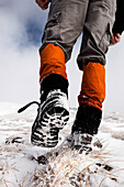 Hiker walking in snow, ascend to Unnutz Mountain (2078 m), Rofan Mountains, Tyrol, Austria