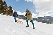 Two young women with a sled, Spitzingsee, Upper Bavaria, Germany