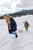 Two young women with a sled, Spitzingsee, Upper Bavaria, Germany