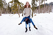 Young woman lifting friend up, Spitzingsee, Upper Bavaria, Germany