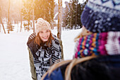 Two young women in snow, Spitzingsee, Upper Bavaria, Germany