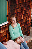 Two young women on a bench, Spitzingsee, Upper Bavaria, Germany