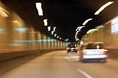 Driving through a tunnel at night with cars seen from the back, Hamburg, Germany, Europe