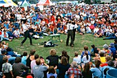 Buskers entertaining a large crowd in Hokitika, New Zealand