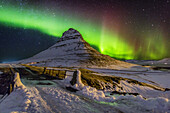 Aurora Borealis or Northern lights over Mt Kirkjufell, Snaefellsnes Peninsula, Iceland.