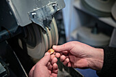 Jeweller polishing a gemstone, Vellberg, Schwaebisch Hall province, Baden-Wuerttemberg, Germany