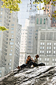 Two women relaxing in Central Park, Manhattan, New York, USA