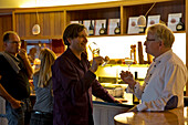Two men enjoying winetasting at Divino winery tasting room and wine shop, Nordheim, Franconia, Bavaria, Germany