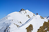 Several persons back-country skiing standing on a ridge between Gammerspitze and Hohe Warte, Gammerspitze, valley of Schmirn, Zillertal Alps, Tyrol, Austria