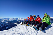 Several persons back-country skiing having a break on summit of Gammerspitze, Gammerspitze, valley of Schmirn, Zillertal Alps, Tyrol, Austria
