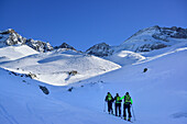 Three persons back-country skiing ascending towards Kleiner Kaserer, Olperer in background, Kleiner Kaserer, valley of Schmirn, Zillertal Alps, Tyrol, Austria