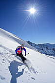Woman back-country skiing downhill from Kleiner Kaserer, Kleiner Kaserer, valley of Schmirn, Zillertal Alps, Tyrol, Austria