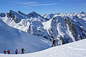 Several persons back-country skiing ascending towards Frauenwand, Zillertal Alps and Stubai Alps in background, Frauenwand, valley of Schmirn, Zillertal Alps, Tyrol, Austria