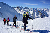 Several persons back-country skiing ascending towards Frauenwand, Zillertal Alps and Stubai Alps in background, Frauenwand, valley of Schmirn, Zillertal Alps, Tyrol, Austria