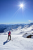 Woman back-country skiing ascending towards Schneespitze, Schneespitze, valley of Pflersch, Stubai Alps, South Tyrol, Italy