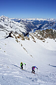 Man and woman back-country skiing ascending towards Schneespitze, Schneespitze, valley of Pflersch, Stubai Alps, South Tyrol, Italy