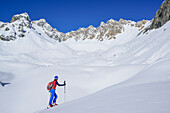 Woman back-country skiing ascending to Col Sautron, Monte Sautron in background, Col Sautron, Valle Maira, Cottian Alps, Piedmont, Italy