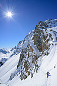 Woman back-country skiing ascending to La Forcellina, Col Sautron, Valle Maira, Cottian Alps, Piedmont, Italy