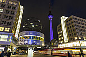 World clock at Alexanderplatz and view towards Alex at night, Berlin, Germany