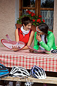 two mountain bikers looking at a menu, Trentino, Italy