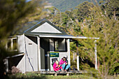 A girl and a woman at the Castle Rock hut, Abel Tasman National Park, South Island, New Zealand