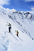 Zwei Personen auf Skitour steigen zum Piz Sursass auf, Piz Nuna im Hintergrund, Piz Sursass, Sesvennagruppe, Engadin, Graubünden, Schweiz