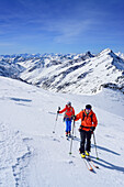 Two persons back-country skiing ascending towards Dreiherrnspitze, Dreiherrnspitze, valley of Ahrntal, Hohe Tauern range, South Tyrol, Italy