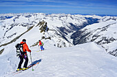Two persons back-country skiing downhill from Dreiherrnspitze, Dreiherrnspitze, valley of Ahrntal, Hohe Tauern range, South Tyrol, Italy
