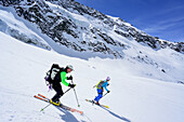 Two persons back-country skiing downhill from Dreiherrnspitze, Dreiherrnspitze, valley of Ahrntal, Hohe Tauern range, South Tyrol, Italy