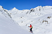 Woman back-country skiing ascending towards Monte Cevedale, Koenigsspitze in the background, Monte Cevedale, valley of Martell, Ortler range, South Tyrol, Italy