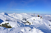Group of persons back-country skiing standing at summit of Pallspitze, Pallspitze, Langer Grund, Kitzbuehel range, Tyrol, Austria