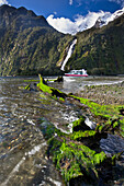 Bowen Falls with cruise vessel passing, Milford Sound, Fjordland National Park, New Zealand
