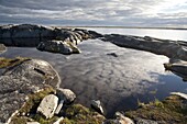 Clouds reflected in pond, Hudson Bay, Churchill, Manitoba, Canada