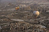 Hot Air Balloons flying over volcanic landscape, Turkey