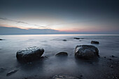 Large stones on a pebble beach at the Baltic Sea in the evening mood, Wustrow, Darss, Mecklenburg Vorpommern, Germany