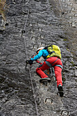 Woman climbing the via ferrata La Resgia, Engadin, Grisons, Switzerland