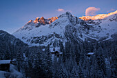 Houses of the village La Fouly in the early morning, behind the summits of Mont Grepillon in the first rays of the sun, Val Ferret, Pennine Alps, canton of Valais, Switzerland