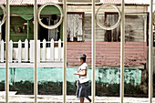 Woman walking along a street, Dominica, Lesser Antilles, Caribbean